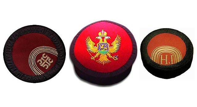 Three traditional caps are shown; two black with gold emblems and a red one with a gold two-headed eagle emblem.