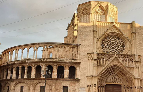 A photo displays a Roman amphitheater and a Gothic cathedral with a rose window under an overcast sky.