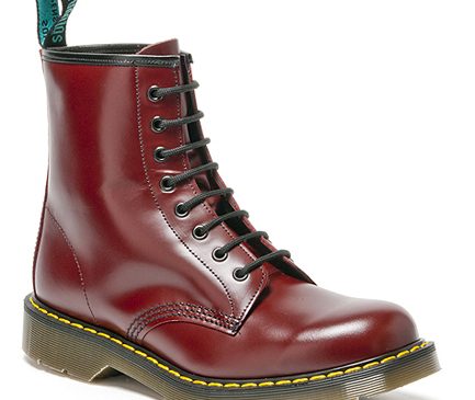 A single burgundy leather lace-up boot with yellow stitching around the sole.