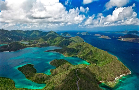 Aerial view of a tropical archipelago with lush green islands surrounded by turquoise waters.