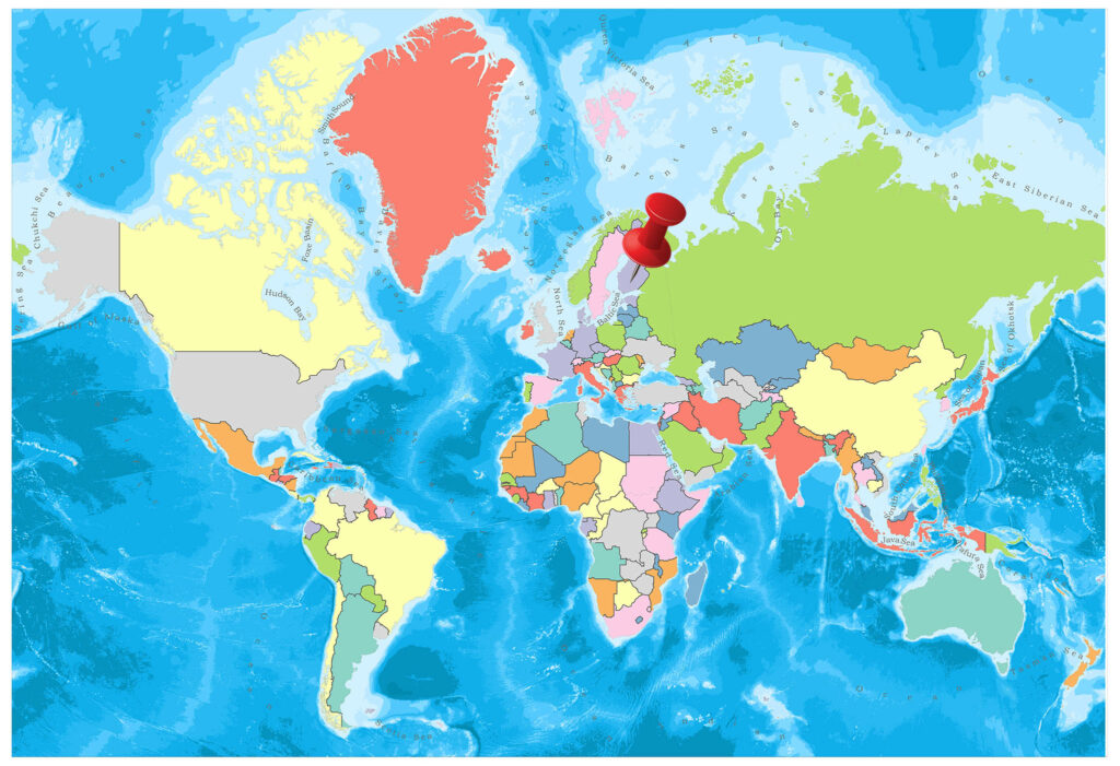 A colorful world map with countries in different colors and a red pin placed on a location in the northern hemisphere.