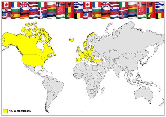 A world map highlighting NATO member countries in yellow, with a row of flags representing various countries at the top of the image.