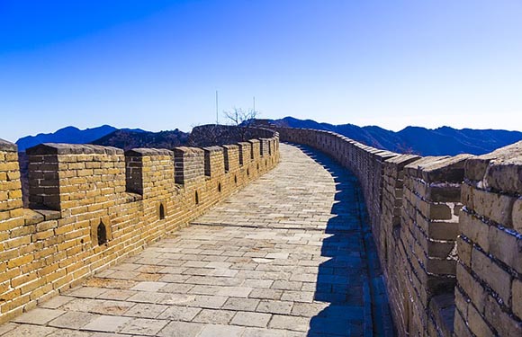 A section of the Great Wall of China with blue sky in the background.