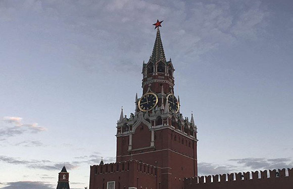 An image of the Spasskaya Tower of the Kremlin with a cloudy sky in the background.