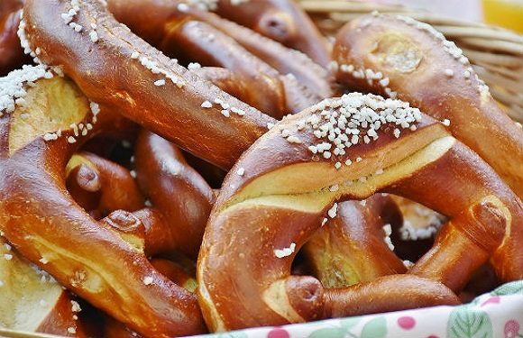 A close-up image of several salted pretzels in a basket.