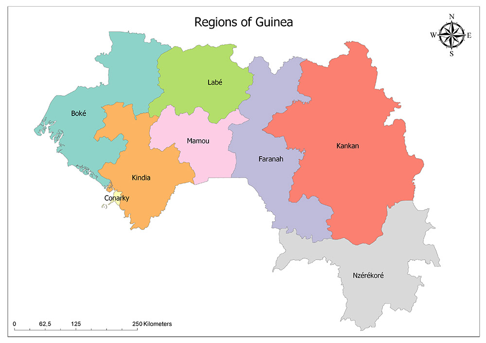 A color-coded map showing the different regions of Guinea, with a compass rose in the upper right corner and a scale in the lower left corner.