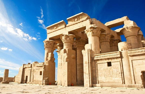 Ancient ruins with columns under a clear blue sky.