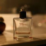 A perfume bottle on a surface with a blurred background.