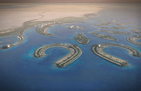 Aerial view of a series of artificial islands in the shape of a world map, surrounded by blue water.