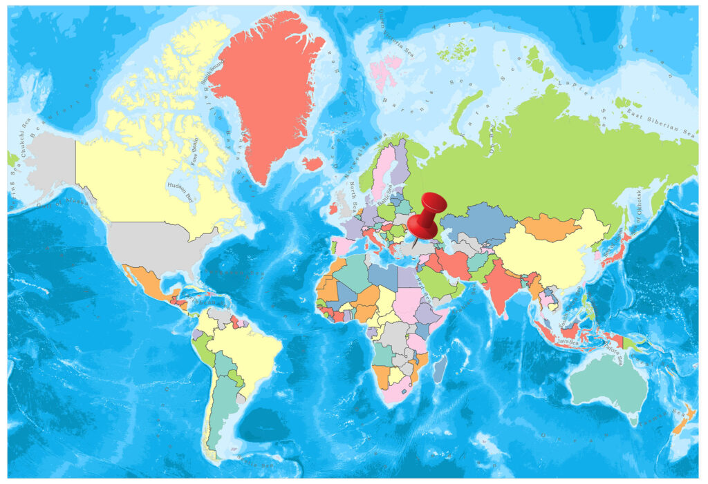 A colorful political world map with countries marked in different colors, oceans in blue, and a series of red location markers over Europe.