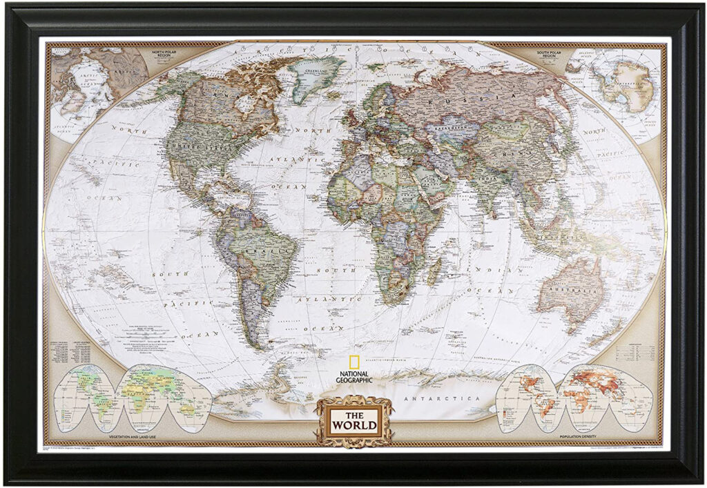 A framed world map with push pins marking locations, hanging on a wall.