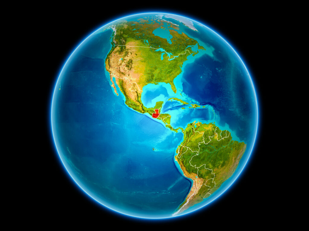 A digital illustration of Earth highlighting Guatemala in red on a world map, with North and South America visible. The image has a black background.