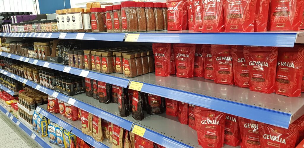 A variety of coffee products on shelves in a store, likely located in Finland.