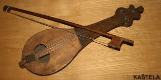 A traditional stringed musical instrument lying on a wooden surface.