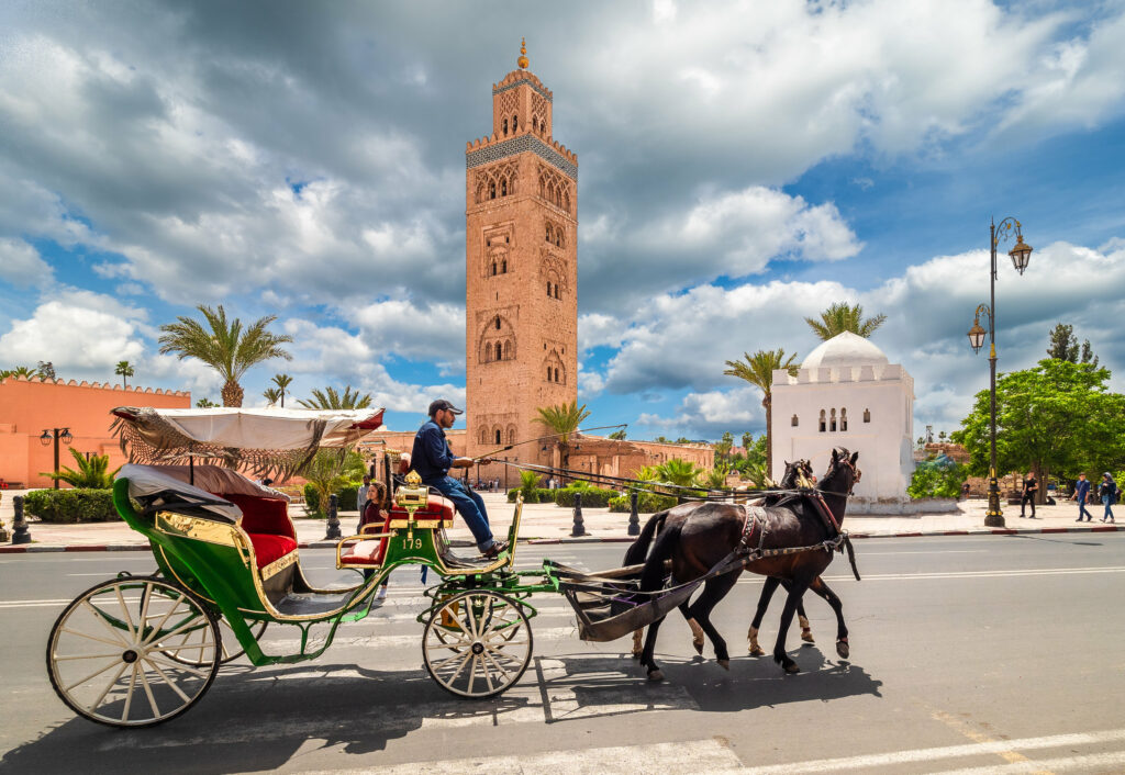 20 Most Beautiful Cities in Africa in 2022 3 Horse carriage with passenger in front of Koutoubia Mosque on Marrakesh, Morocco
