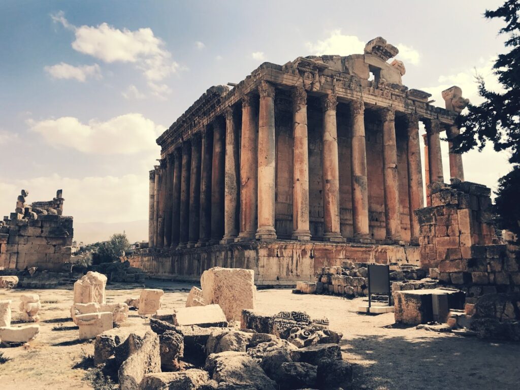 Ancient temple ruins with columns under a clear sky, possibly located in Greece.