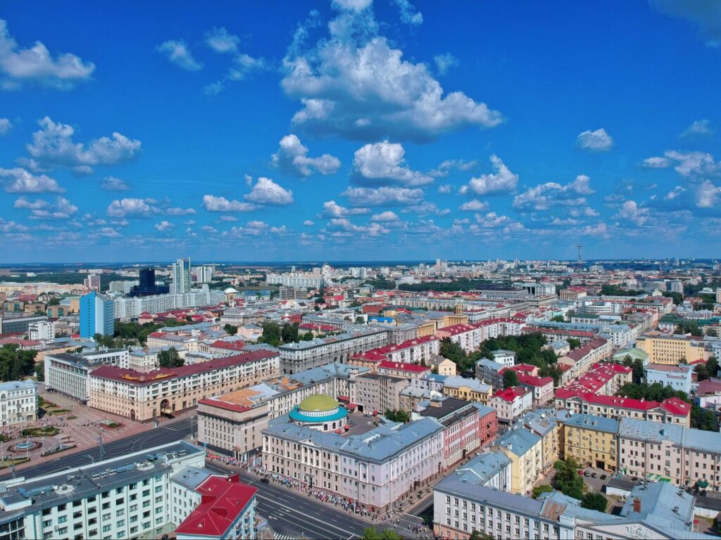 The city of Minsk under a blue sky with clouds.