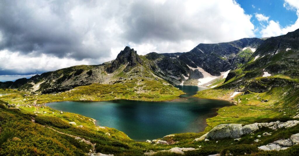 One of the Seven Rila Lakes in Bularia under a cloudy sky.