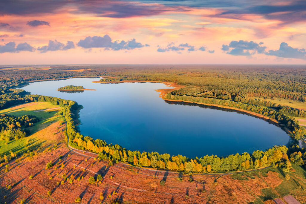 Beautiful view from flying drone of Krymne Lake. Majestic sunset Shatsky National Park, Volyn region, Ukraine, Europe. Beauty of nature concept background.