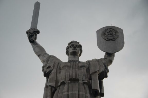 The Motherland Monument in Kyiv, Ukraine is a large statue of a woman holding a sword and shield.