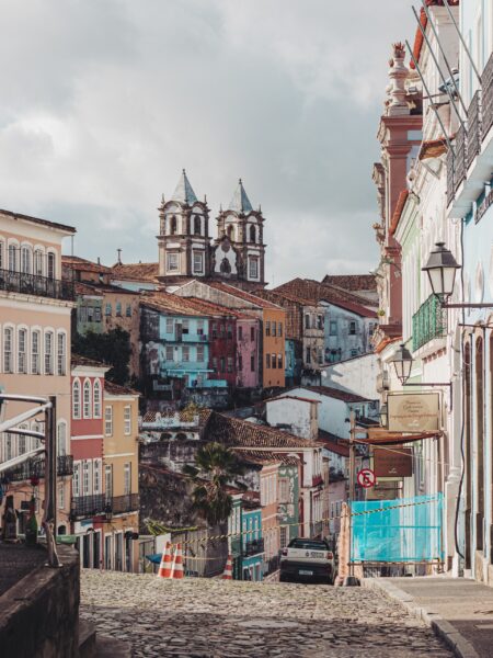 The historic Pelourinho district in Salvador, Brazil features colorful colonial buildings, cobblestone streets, and a church.