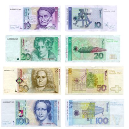 A collage of various denominations of German Mark banknotes, with different historical figures and architectural elements depicted on each note.