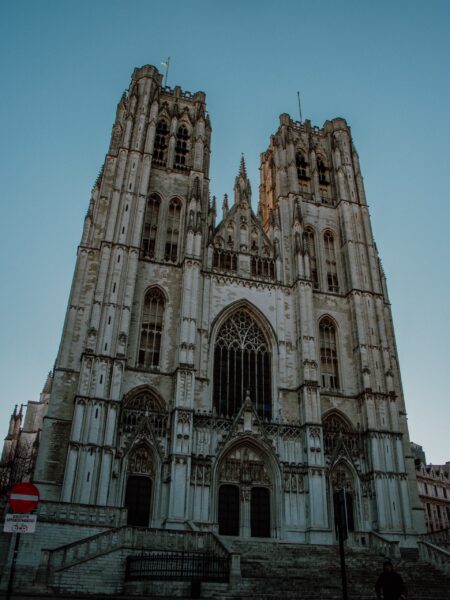 An image of the Cathedral of St. Michael and St. Gudula in Brussels, showing its Gothic architecture with two tall towers and a large rose window.