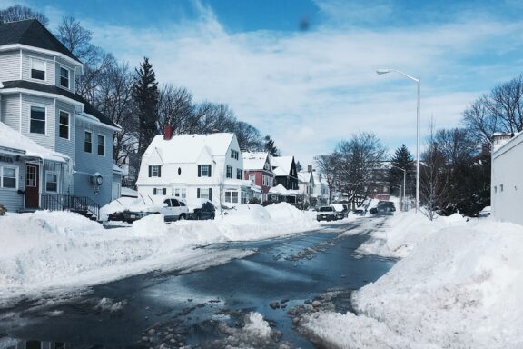 A winter scene in Massachusetts with houses along a snow-covered street.