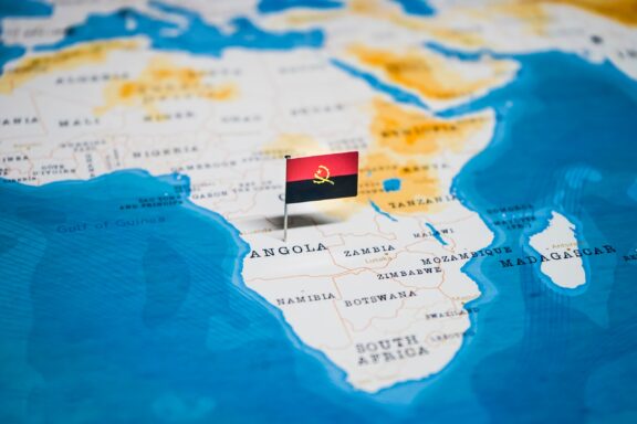 The flag of Angola pinning the location of Angola