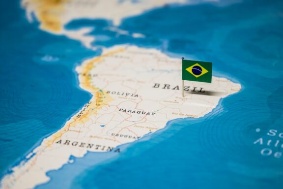 Brazil on the map, pinned by the vibrant colors of its flag