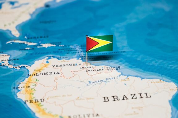 Guyana's location on the northern coast of South America pinned by its national flag