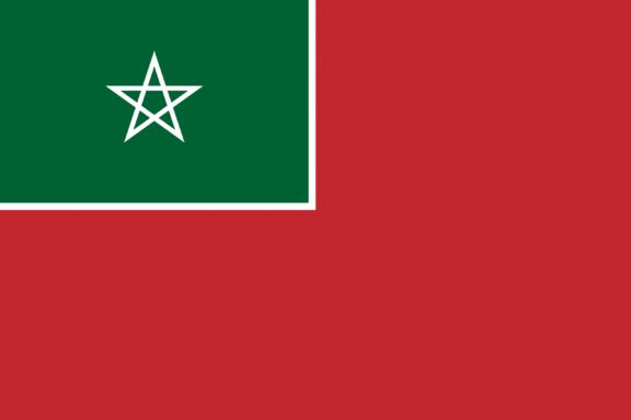 A flag with a red field and a green pentagram star in the center of a black-bordered green rectangle in the upper hoist corner.