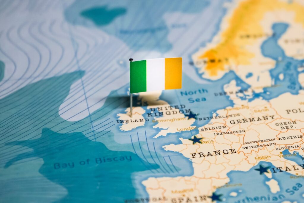 Ireland's location west of the United Kingdom marked by a pin of its national flag