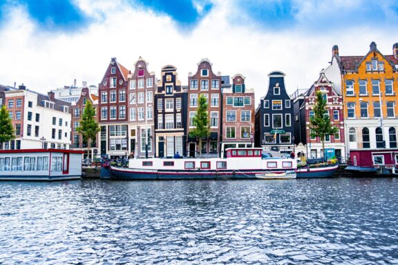 Colorful traditional Dutch houses by the canal in Amsterdam.