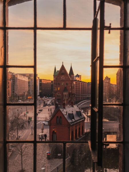 View of Hamburg, Germany at sunset seen through a window with divided panes.