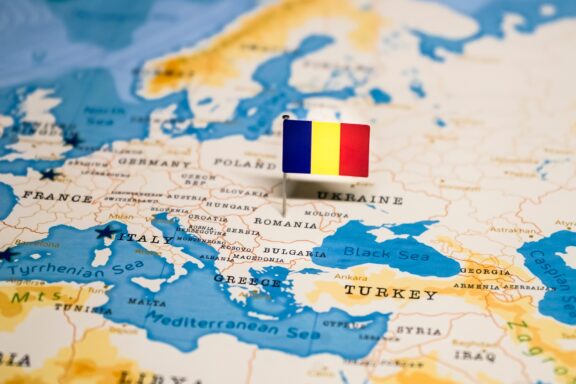 Map of Europe with a Pin Flag on Romania Romania pointed out on the map by a flag pin.