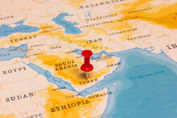 Pin pointing out Yemen on a map.