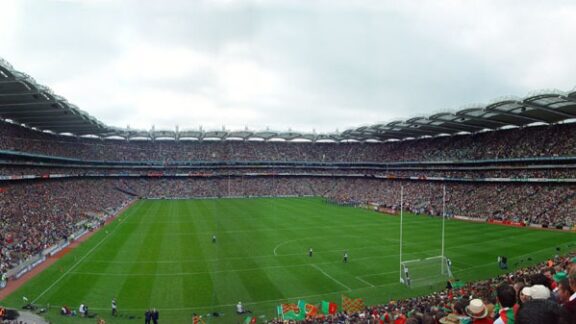 A daytime event at Dublin's Croke Park stadium, filled with spectators, highlights its large pitch and tiered seating.