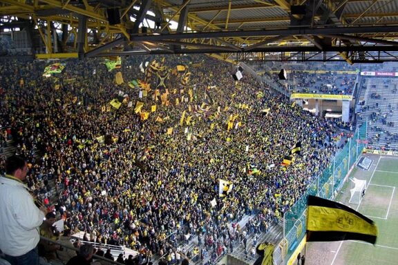 Crowd of spectators in the South Stand at Signal Iduna Park, Dortmund, during a football match.