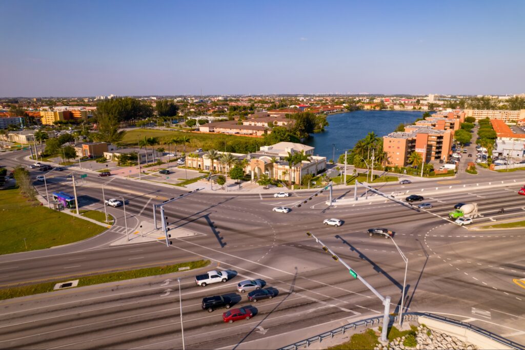 Aerial shot of a busy intersection in Hialeah Gardens, Miami, near residences and water.