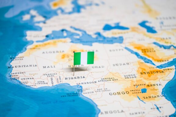 Nigeria Flag Pin on World Map Pinned location of Abuja, Nigeria