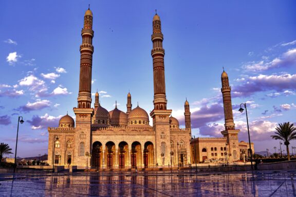 A mosque with two tall minarets against a blue sky, possibly Al Saleh Mosque.