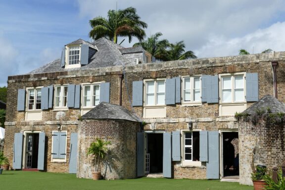 A historic stone building with blue shutters at Nelson's Dockyard.