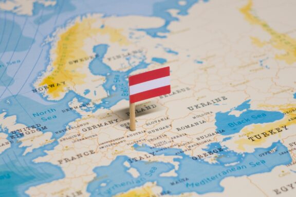 Austrian flag pin on the location of Austria in Central Europe