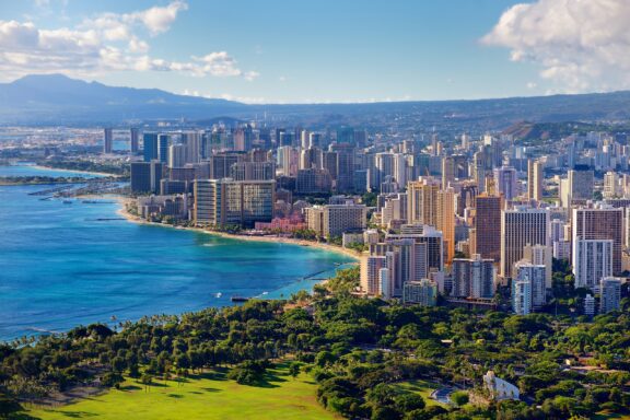 Aerial view of Honolulu city with high-rise buildings along the coast, Oahu, Hawaii.