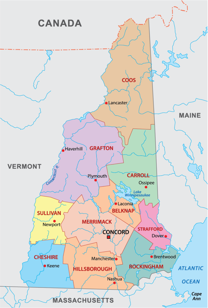 A color-coded map showing the counties of New Hampshire with labels, bordered by Canada, Maine, Vermont, Massachusetts, and the Atlantic Ocean.