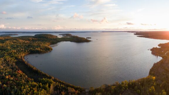 Aerial panoramic landscape view of a beautiful bay on the Great Lakes, Lake Huron, during a vibrant sunset. Located Northwest from Toronto, Ontario, Canada.