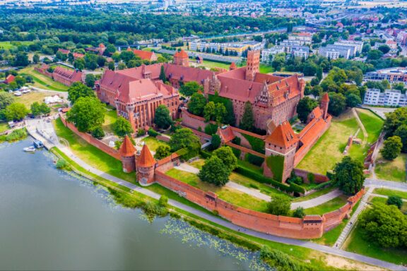 Aerial panoramic view of the gothic Grand Masters’ Palace in the High Castle part of the medieval Teutonic Order Castle by the Nogat river in Malbork, Poland.