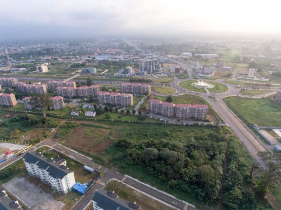 Aerial view of Malabo, the capital of Equatorial Guinea, showing a mix of residential buildings, roads, and green areas.