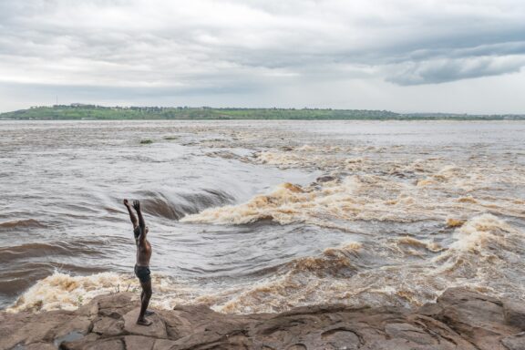 African boy traditional dane on the congo river.